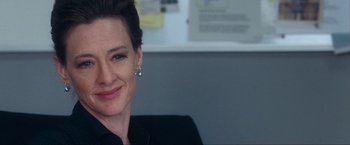 Movie still from “War, Inc.” (2008), directed by Joshua Seftel – A person wearing a black shirt; Close Up shot, Over the shoulder angle