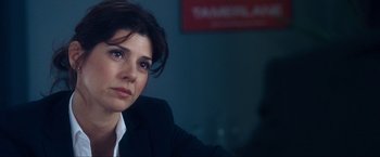 Movie still from “War, Inc.” (2008), directed by Joshua Seftel – A person wearing a suit and tie; Close Up shot, Over the shoulder angle