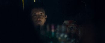 Movie still from “War, Inc.” (2008), directed by Joshua Seftel – A man sitting in front of a mirror in a dark room; Close Up shot, Over the shoulder angle