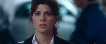 Movie still from “War, Inc.” (2008), directed by Joshua Seftel – A person wearing a suit and tie; Close Up shot, Over the shoulder angle