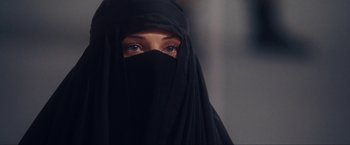 Movie still from “War, Inc.” (2008), directed by Joshua Seftel – A person wearing a black veil; Close Up shot, Over the shoulder angle