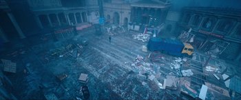 Movie still from “War, Inc.” (2008), directed by Joshua Seftel – A person walks through debris in an abandoned building; Extreme Wide shot, High angle