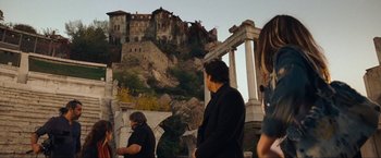 Movie still from “War, Inc.” (2008), directed by Joshua Seftel – A group of people standing on top of a hill; Extreme Wide shot, Low angle