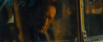 Movie still from “War, Inc.” (2008), directed by Joshua Seftel – A person looking at a computer screen; Close Up shot, Low angle