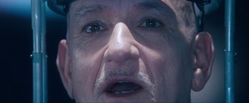 Movie still from “War, Inc.” (2008), directed by Joshua Seftel – An old man with a beard and a mustache looking at the camera; Extreme Close Up shot, Low angle
