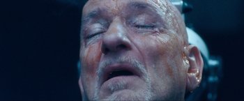 Movie still from “War, Inc.” (2008), directed by Joshua Seftel – An old man with a beard and a white mustache; Extreme Close Up shot, Overhead angle