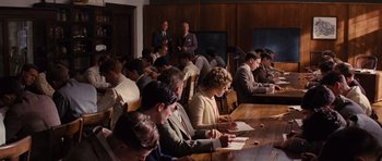 Movie still from “Water for Elephants” (2011), directed by Francis Lawrence – A group of people sitting at a long wooden table; Wide shot, High angle