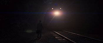 Movie still from “Water for Elephants” (2011), directed by Francis Lawrence – A man standing on a train track at night; Extreme Wide shot, Low angle