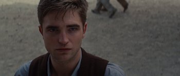 Movie still from “Water for Elephants” (2011), directed by Francis Lawrence – A person wearing a shirt and vest; Close Up shot, Over the shoulder angle