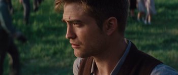 Movie still from “Water for Elephants” (2011), directed by Francis Lawrence – A person wearing a vest looking to the side; Close Up shot, Over the shoulder angle