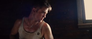 Movie still from “Water for Elephants” (2011), directed by Francis Lawrence – A young man with a beard is looking at the camera; Close Up shot, Low angle