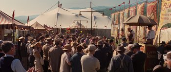 Movie still from “Water for Elephants” (2011), directed by Francis Lawrence – A group of people standing in front of a white tent; Wide shot, High angle