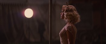 Movie still from “Water for Elephants” (2011), directed by Francis Lawrence – A woman with blonde hair wearing a silver dress; Medium shot, Over the shoulder angle