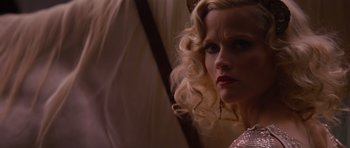 Movie still from “Water for Elephants” (2011), directed by Francis Lawrence – A woman with long blonde curly hair looking at the camera; Close Up shot, Low angle