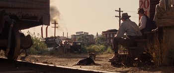 Movie still from “Water for Elephants” (2011), directed by Francis Lawrence – A man and a dog sitting on the ground; Wide shot, Over the shoulder angle