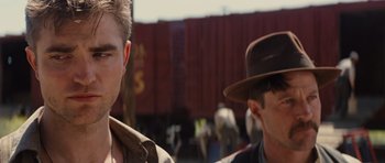 Movie still from “Water for Elephants” (2011), directed by Francis Lawrence – A man in a brown hat and a man in a black hat; Close Up shot, Over the shoulder angle