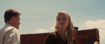 Movie still from “Water for Elephants” (2011), directed by Francis Lawrence – A woman with blonde curly hair wearing a brown sweater and a colorful scarf; Close Up shot, Low angle