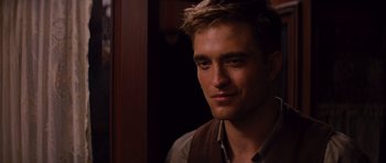 Movie still from “Water for Elephants” (2011), directed by Francis Lawrence – A person wearing a shirt and vest; Close Up shot, Over the shoulder angle