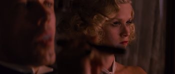 Movie still from “Water for Elephants” (2011), directed by Francis Lawrence – A woman with blonde curly hair looking at the camera; Close Up shot, Over the shoulder angle