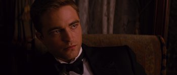 Movie still from “Water for Elephants” (2011), directed by Francis Lawrence – A person wearing a suit and bow tie; Close Up shot, Over the shoulder angle