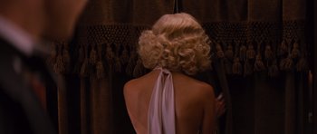 Movie still from “Water for Elephants” (2011), directed by Francis Lawrence – A woman with blonde hair wearing a white dress; Medium shot, Over the shoulder angle