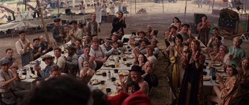 Movie still from “Water for Elephants” (2011), directed by Francis Lawrence – A group of people sitting at a table with plates of food on it; Wide shot, High angle