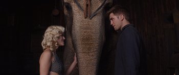 Movie still from “Water for Elephants” (2011), directed by Francis Lawrence – A man and a woman standing next to an elephant; Medium shot, Low angle