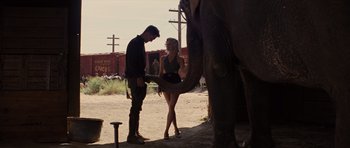 Movie still from “Water for Elephants” (2011), directed by Francis Lawrence – A man and a woman standing next to an elephant; Wide shot, Low angle