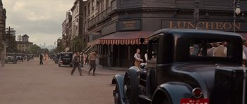 Movie still from “Water for Elephants” (2011), directed by Francis Lawrence – An old fashioned car driving down a street; Wide shot, High angle