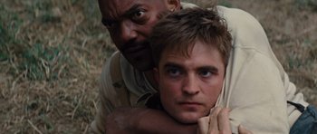 Movie still from “Water for Elephants” (2011), directed by Francis Lawrence – A man leaning on another man's shoulder in a field; Close Up shot, High angle