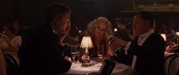 Movie still from “Water for Elephants” (2011), directed by Francis Lawrence – A group of people sitting at a table with wine glasses; Medium shot, Over the shoulder angle