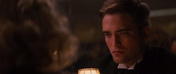 Movie still from “Water for Elephants” (2011), directed by Francis Lawrence – A man in a priest's outfit looking at a candle; Close Up shot, Over the shoulder angle