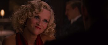 Movie still from “Water for Elephants” (2011), directed by Francis Lawrence – A woman with blonde curly hair sitting in front of a man in a suit; Close Up shot, Over the shoulder angle
