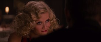 Movie still from “Water for Elephants” (2011), directed by Francis Lawrence – A woman with blonde hair and red lipstick looking into the camera; Close Up shot, Over the shoulder angle