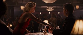 Movie still from “Water for Elephants” (2011), directed by Francis Lawrence – A woman in a red dress at a table with a man; Medium shot, Over the shoulder angle
