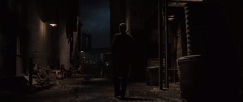 Movie still from “Water for Elephants” (2011), directed by Francis Lawrence – A man in a suit standing in the dark; Wide shot, Over the shoulder angle