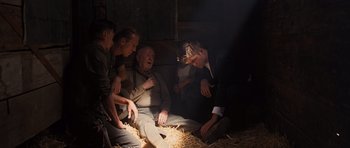 Movie still from “Water for Elephants” (2011), directed by Francis Lawrence – A group of men sitting around in a barn; Medium shot, High angle