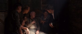 Movie still from “Water for Elephants” (2011), directed by Francis Lawrence – A group of people gathered around a man in a suit; Medium shot, Over the shoulder angle