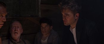 Movie still from “Water for Elephants” (2011), directed by Francis Lawrence – Two men sitting next to each other in the dark; Medium shot, Low angle