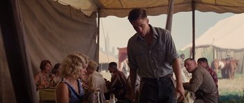 Movie still from “Water for Elephants” (2011), directed by Francis Lawrence – A man standing in front of a group of people; Medium shot, Over the shoulder angle