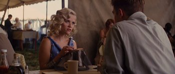 Movie still from “Water for Elephants” (2011), directed by Francis Lawrence – A woman sitting in front of a man at a table; Medium shot, Over the shoulder angle