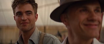 Movie still from “Water for Elephants” (2011), directed by Francis Lawrence – A man in a hat and a man in a shirt and tie; Close Up shot, Over the shoulder angle