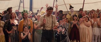 Movie still from “Water for Elephants” (2011), directed by Francis Lawrence – A group of people standing around a crowd of people; Medium shot, High angle