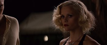 Movie still from “Water for Elephants” (2011), directed by Francis Lawrence – A woman with blonde curly hair wearing a black top; Close Up shot, Low angle