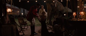 Movie still from “Water for Elephants” (2011), directed by Francis Lawrence – A man and a woman in front of an elephant at night; Wide shot, Over the shoulder angle