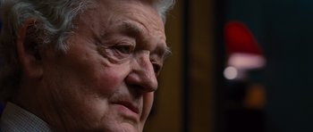 Movie still from “Water for Elephants” (2011), directed by Francis Lawrence – An older man with a gray beard looking to his left; Close Up shot, Over the shoulder angle
