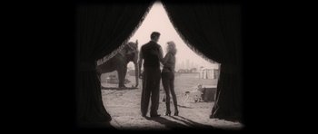 Movie still from “Water for Elephants” (2011), directed by Francis Lawrence – A man and a woman standing next to an elephant; Wide shot, Low angle