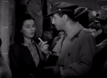 Movie still from “Waterloo Bridge” (1940), directed by Mervyn LeRoy – A man and a woman are talking to each other; Medium shot, High angle