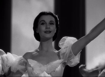 Movie still from “Waterloo Bridge” (1940), directed by Mervyn LeRoy – A black - and - white photo of a woman wearing a dress; Close Up shot, Low angle