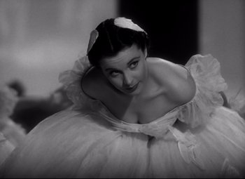 Movie still from “Waterloo Bridge” (1940), directed by Mervyn LeRoy – A black - and - white photo of a woman in a white dress; Close Up shot, Low angle